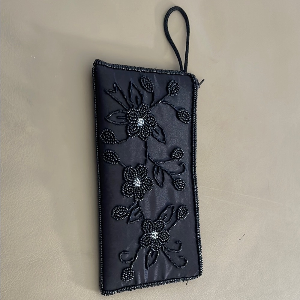 Elegant Black Beaded Clutch black colt beads intact. Zipper closure 7 1/2x 4